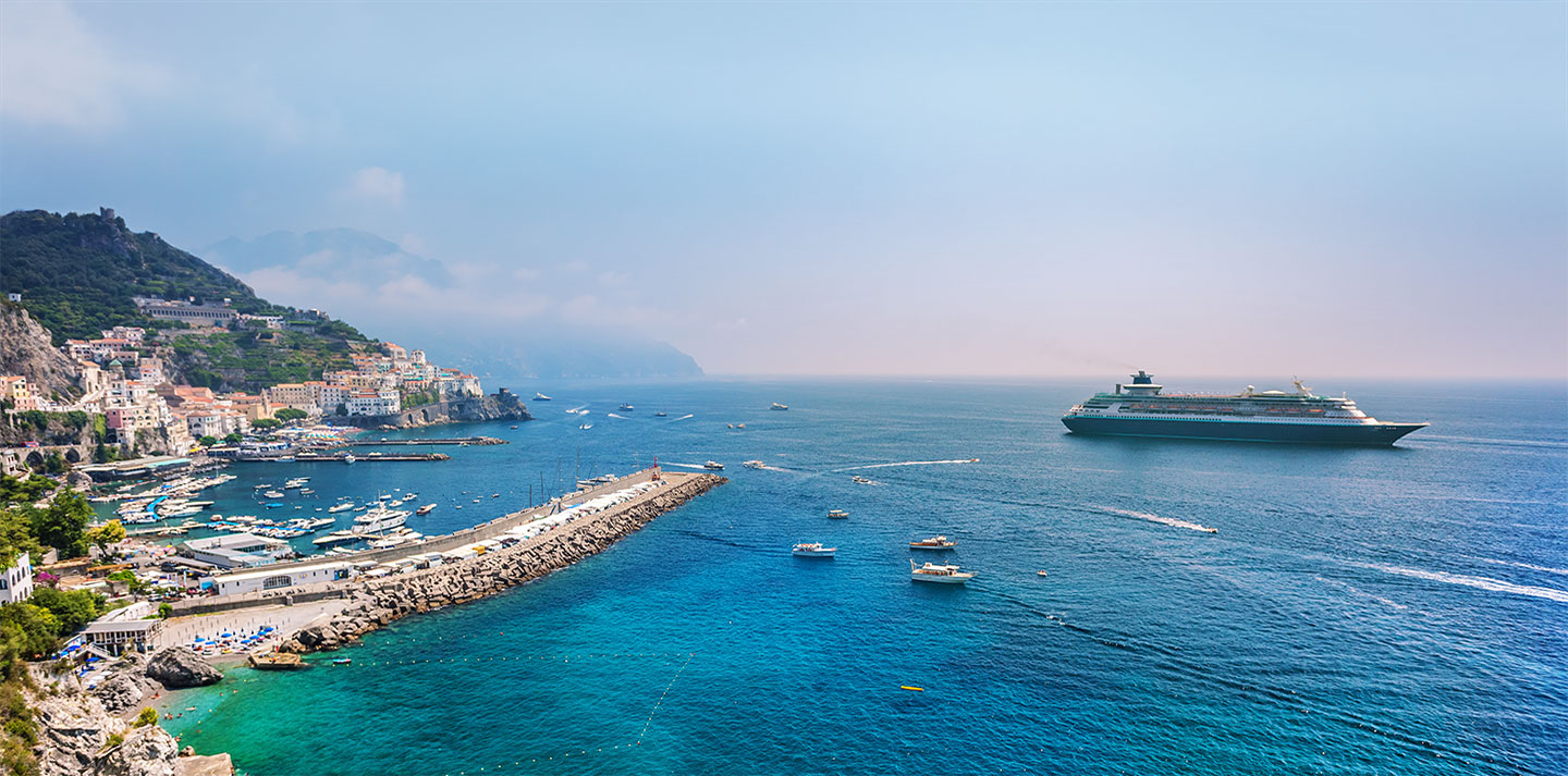 Consider cruise insurance coverage for trips like the one shown, with a cruise ship near the coastline.