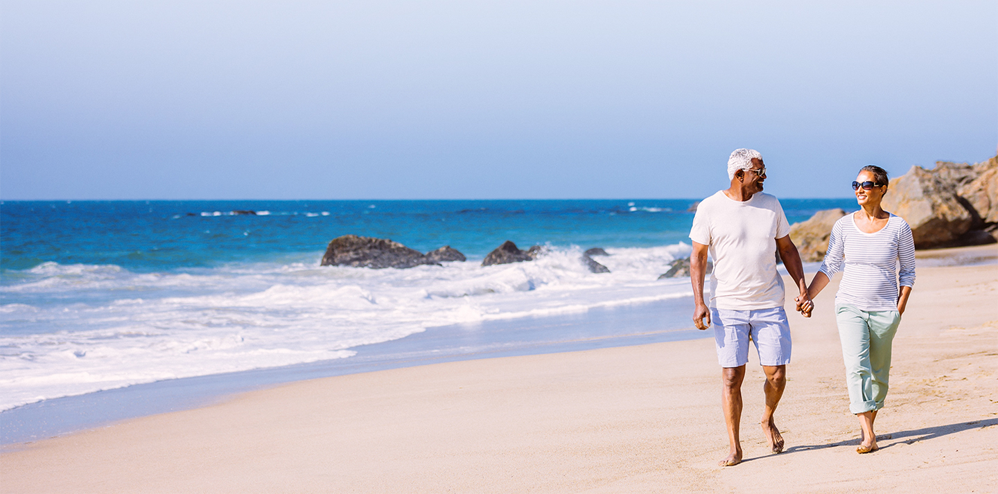 Senior couple walking on beach