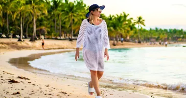 Woman walking on the beach during Caribbean travel.