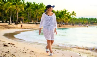 Woman walking on the beach during Caribbean travel.