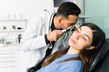 Doctor examining patient's ear