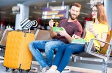 Couple eating food at airport gate